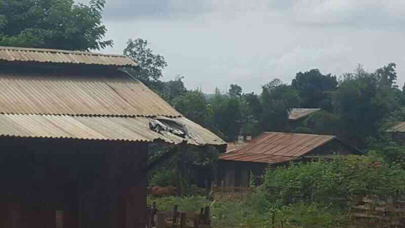 Village roof destroyed by mortar shell.